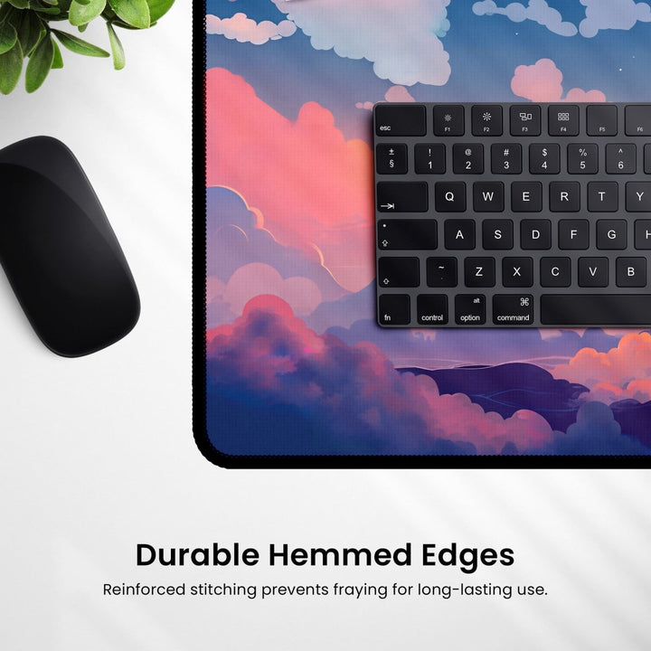 Home Decor - Close - up of a computer keyboard and mouse on a scenic Cloud Desk Mat – Cute Large Mouse Pad for Gaming & Office Setup with a text overlay. The text reads, "Durable Hemmed Edges - Reinforced stitching prevents fraying for long - lasting use. - Kaladyn Designs