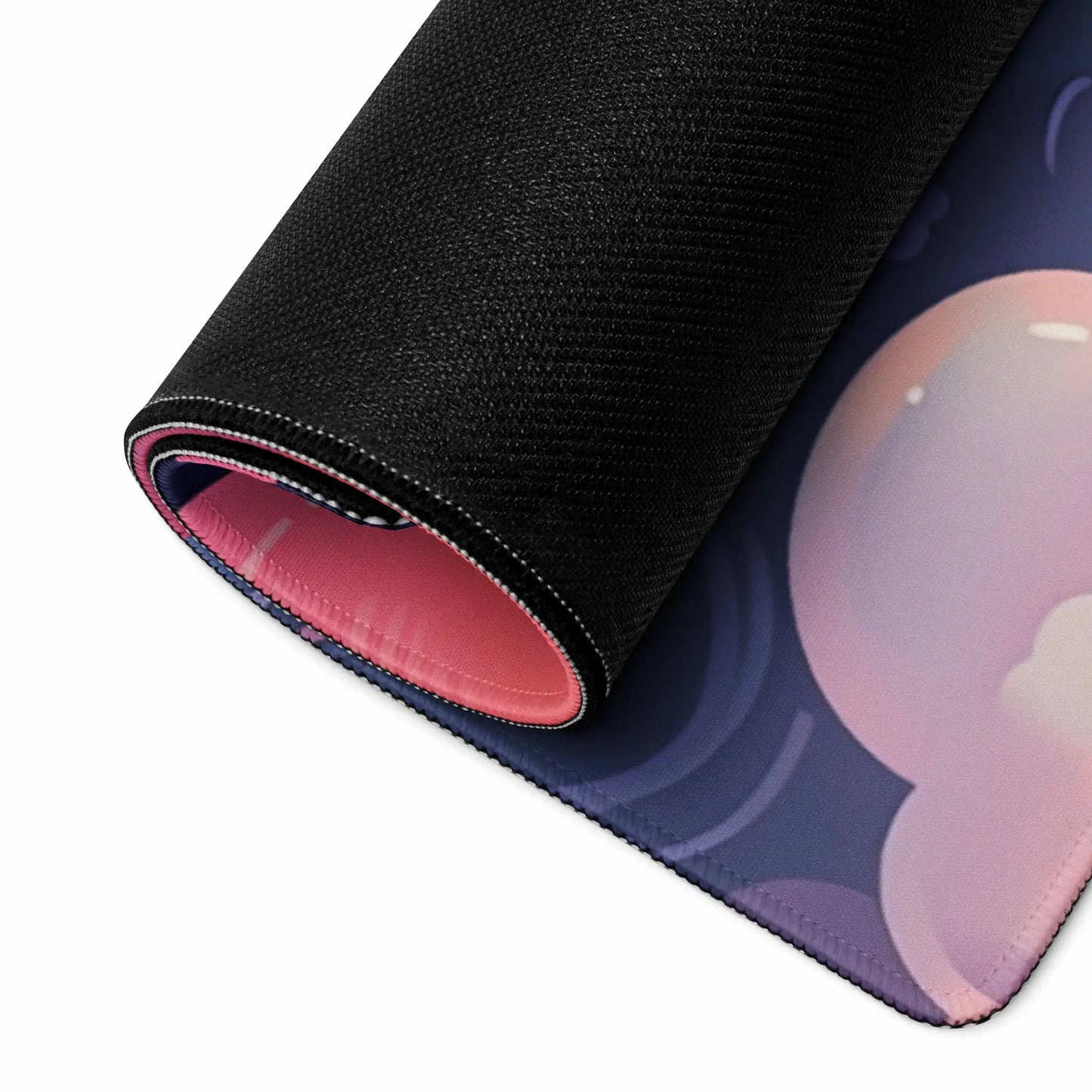A rolled up gaming pad with hemmed edges and a rubber bottom