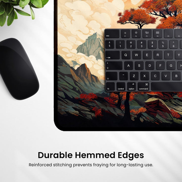 Home Decor - A close - up image showcases a black mouse and keyboard resting on the Japanese Desk Mat – Large Mouse Pad with Japanese Art - Inspired Design for Office & Gaming, which features a vibrant mountain and forest theme. The desk mat has durable hemmed edges with reinforced stitching to prevent fraying, ensuring long - lasting use. The text below reads: "Durable Hemmed Edges: Reinforced stitching prevents fraying for long - lasting use. - Kaladyn Designs