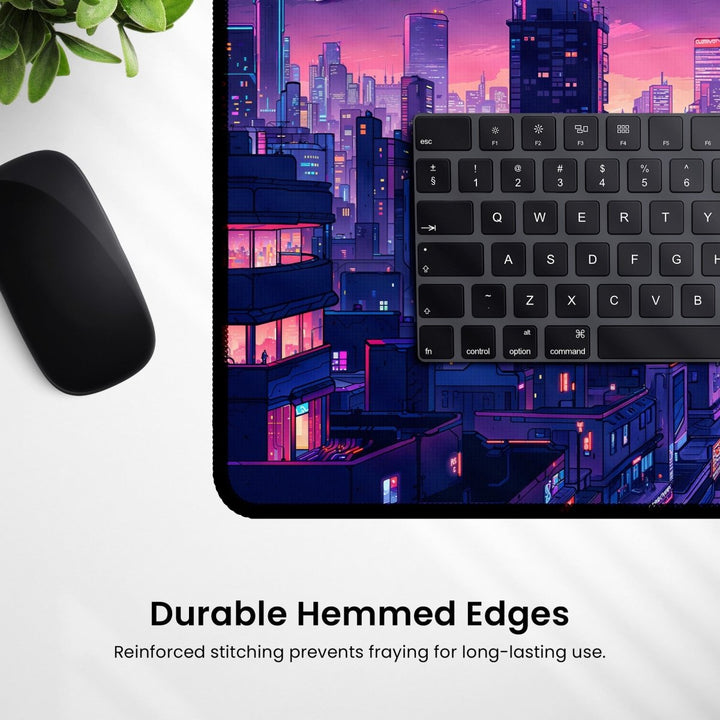 Home Decor - A sleek black keyboard and mouse rest on the Neon City Desk Mat - Anime Gaming Mouse Pad & Vaporwave Aesthetic Decor, which is alive with vibrant building graphics. The text at the bottom highlights "Durable Hemmed Edges" for reinforced stitching, ensuring long - lasting use in your gaming setup. - Kaladyn Designs