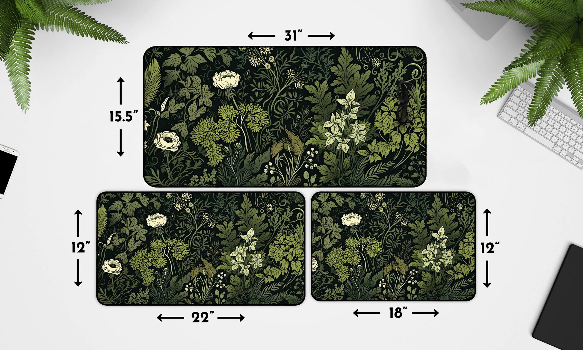 Graphic showing three different sizes of dark green floral-themed desk mats with dimensions: 31x15.5 inches, 22x12 inches, and 18x12 inches.