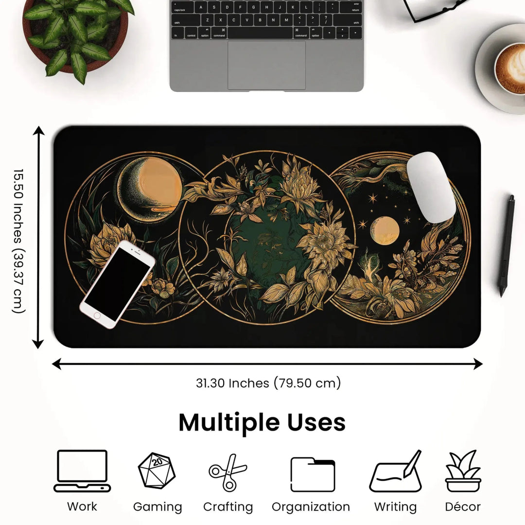 A desk setup featuring the Art Nouveau Celestial Moon Desk Mat – Witch Aesthetic Gaming Mouse Pad. This black rectangular mouse pad showcases a mystical celestial design in golden hues and measures 31.30 inches by 15.50 inches, providing ample space for an open laptop and smartphone. Icons below highlight its versatility for work, gaming, crafting, organizing, writing, and décor.