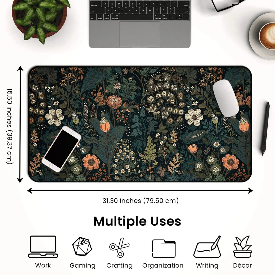 The Dark Cottagecore Botanical Desk Mat is displayed on a desk accompanied by a phone, mouse, and keyboard. This desk mat measures 31.30 inches by 15.50 inches and features icons indicating its versatility for work, gaming, crafting, organization, writing, and décor—all presented in a charming Dark Cottagecore aesthetic.