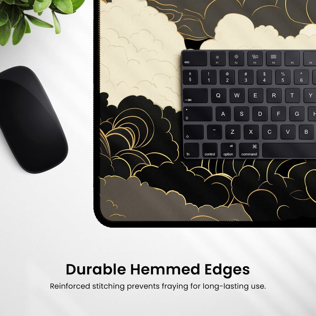 Home Decor - A mouse, keyboard, and the Dark Cloud Desk Mat – Celestial Gaming Mouse Pad with a cloud pattern are arranged on a white surface. The mat boasts durable hemmed edges and reinforced stitching. A plant is partially visible in the top left corner, adding a touch of nature to this sleek gaming desk setup. - Kaladyn Designs