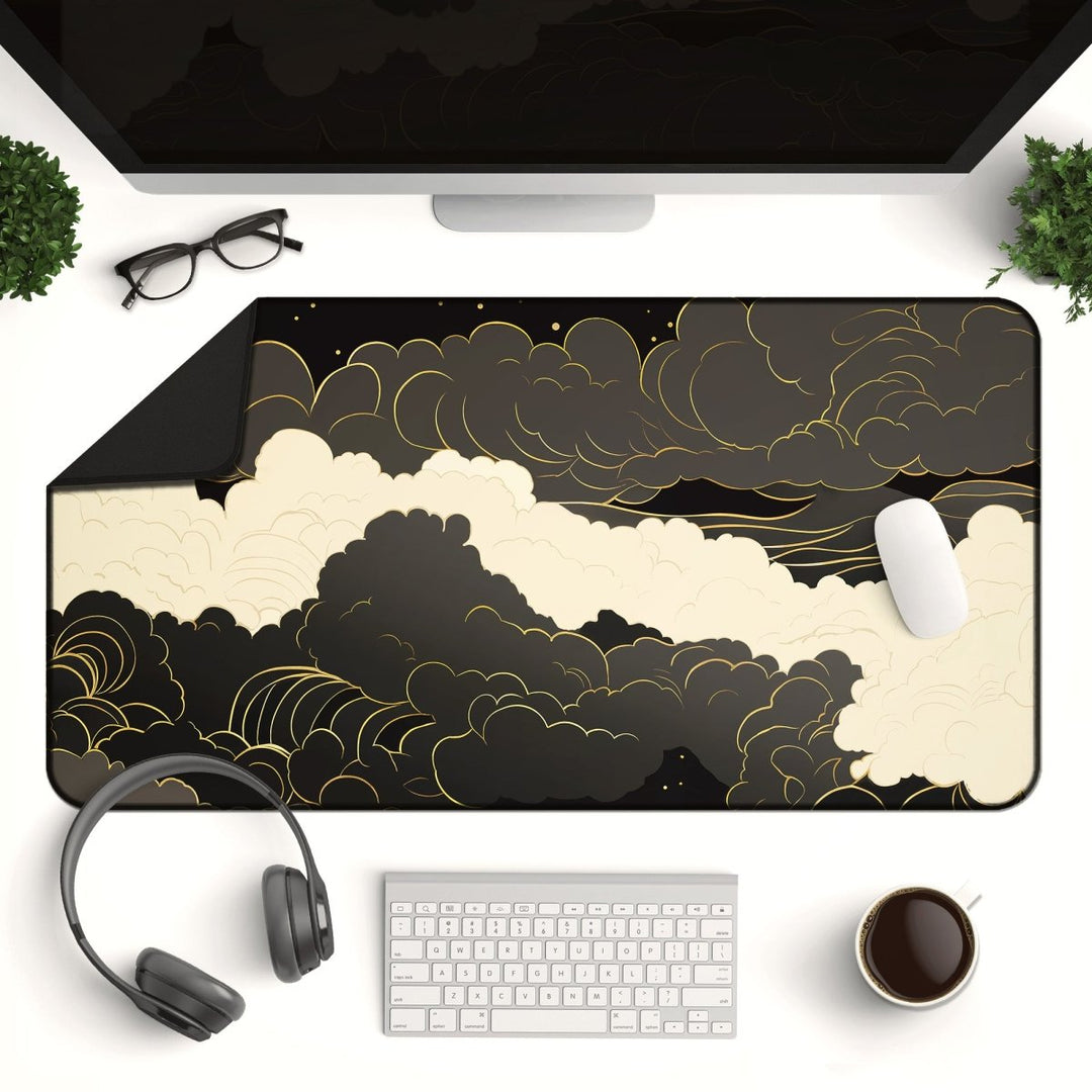 Home Decor - Discover an elegant gaming desk setup featuring the Dark Cloud Desk Mat – Celestial Gaming Mouse Pad, a large non - slip desk pad enhanced with dark clouds and golden accents. The workspace is complete with headphones, a keyboard, mouse, coffee cup, computer monitor, glasses, and plants to inspire creativity. - Kaladyn Designs