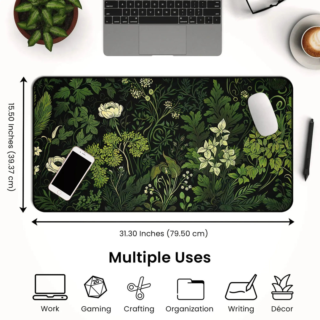 Home Decor - A desk setup features a laptop, mouse, and phone on a Floral Sage Green Botanical Desk Mat with a floral pattern measuring 31.30 by 15.50 inches. Icons below the image indicate multiple uses: work, gaming, crafting, organization, writing, and décor. - Kaladyn Designs