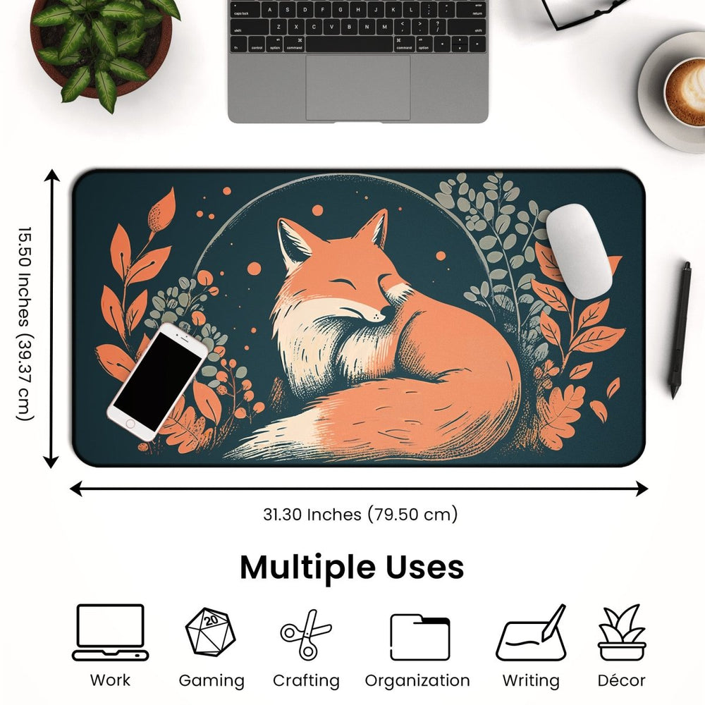 Home Decor - The Fox Desk Mat – Large Cute Fox Mouse Pad for Office & Gaming Setup measures 31.30 inches by 15.50 inches and features a sleeping fox illustration surrounded by foliage. An overhead view showcases a phone, mouse, and laptop on the mat, with icons below indicating its versatility for work, gaming, crafting, organization, writing, and nature - themed decor. - Kaladyn Designs