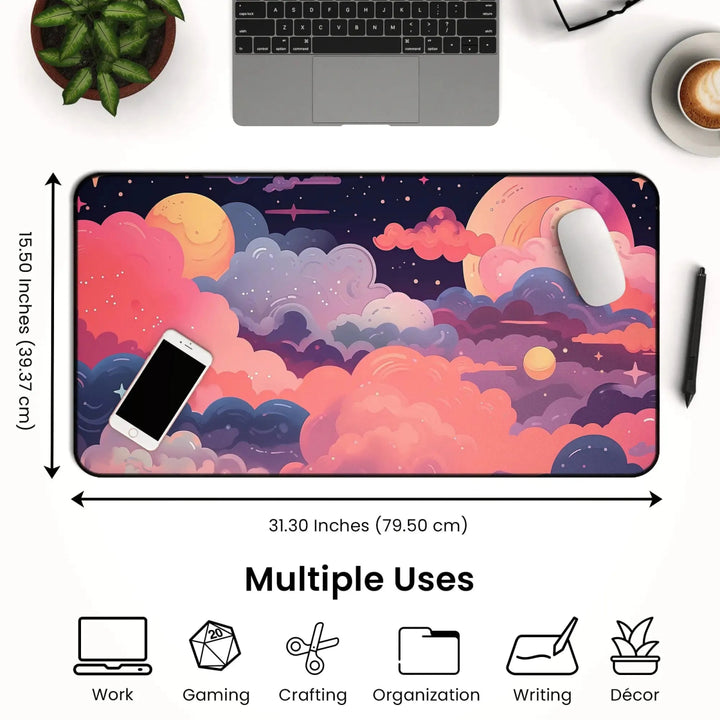 A large Kawaii Anime Desk Mat – Pastel Pink Night Sky Mouse Pad & Gaming Mat measuring 31.30 inches by 15.50 inches with a vibrant cosmic design featuring clouds, stars, and planets. The mat is shown with a smartphone and mouse on top, illustrating multiple uses such as work, gaming, crafting, organization, writing, and décor.