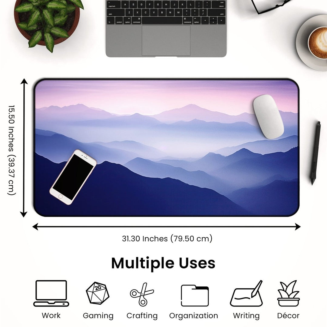 Home Decor - A workspace setup with a Mountain Desk Mat – Large Nature Mouse Pad for Office or Gaming Setup featuring a serene mountain landscape design. The mat measures 31.30 inches by 15.50 inches and includes a smartphone, wireless mouse, laptop, and various symbols indicating uses such as work, gaming, crafting, organization, writing, and décor. - Kaladyn Designs